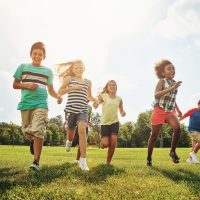 Happy,Friends,,Children,And,Running,With,Grass,Field,In,Nature